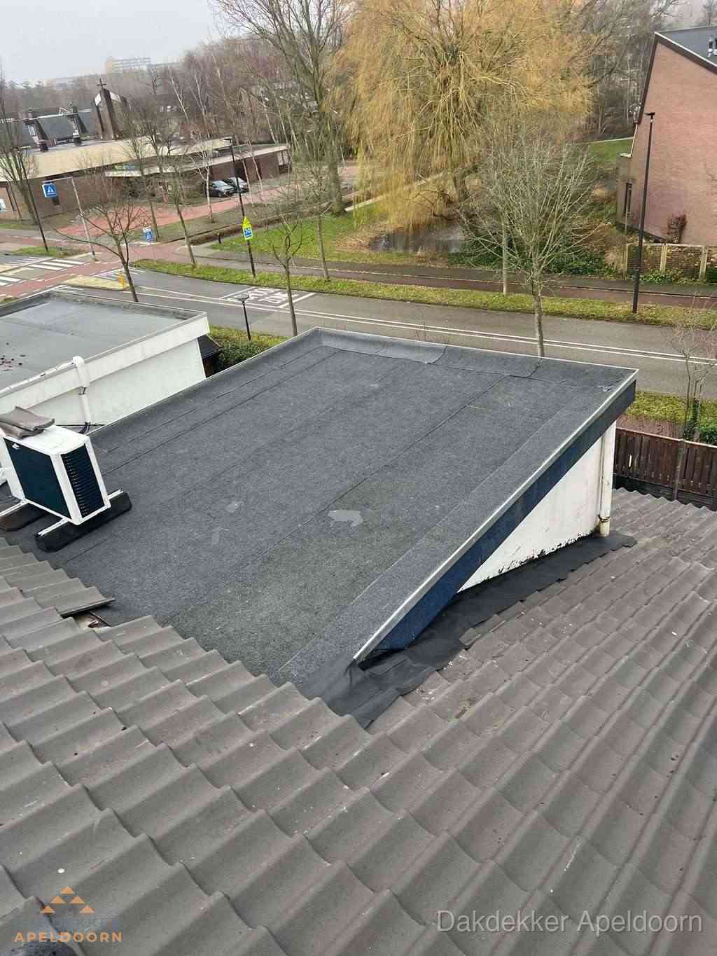 Plat dak met bitumen dakbedekking naast schuin pannendak in Apeldoorn